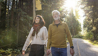 A couple enjoying a free, self-guided tour of Whistler's Cultural Connector in the Village